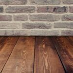 wood floors and humidity. Image of wood floors meeting a brick wall.