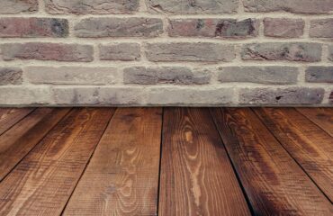 wood floors and humidity. Image of wood floors meeting a brick wall.