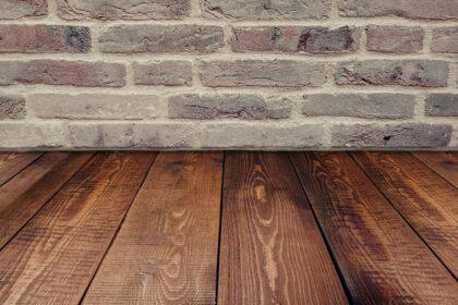 wood floors and humidity. Image of wood floors meeting a brick wall.
