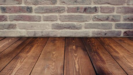 wood floors and humidity. Image of wood floors meeting a brick wall.